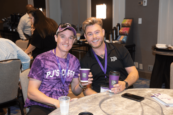 What to Expect at the 2024 PJ’s Coffee Conference: two men holding PJs coffee cups