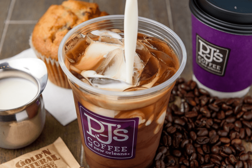 PJ's Coffee product shot with iced coffee, hot coffee, coffee beans, muffin, and frothed milk